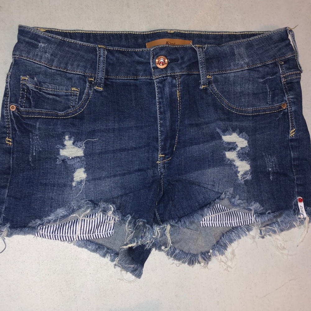 Denim shorts with blue and white striped detail pockets in front